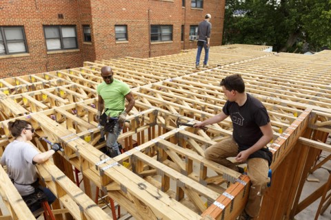 Volunteers hammering at construction site