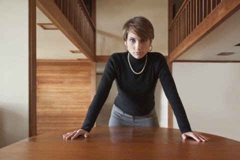 Caucasian woman leaning on table