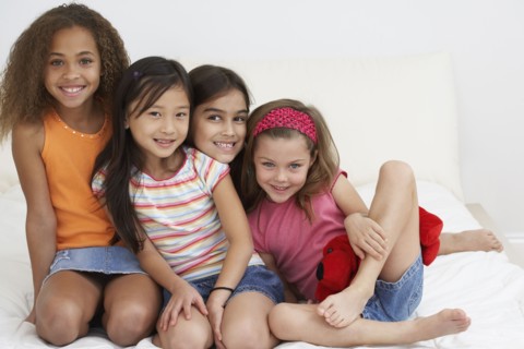 Group of young girls hugging and smiling