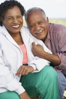 Senior couple smiling and hugging outdoors