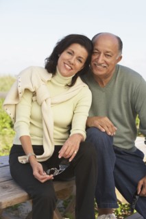 Senior couple hugging and smiling outdoors