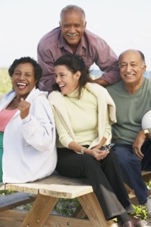 Two senior couples laughing outdoors