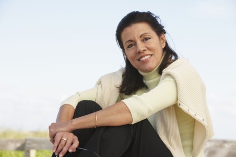 Middle-aged woman sitting outdoors