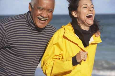 Senior couple laughing at beach