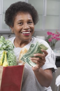 Senior African American woman with money and groceries