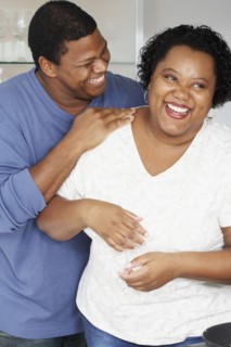 African couple hugging and laughing