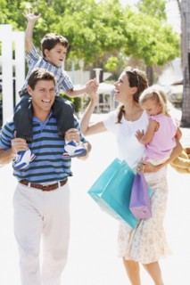 Hispanic family walking with shopping bags outdoors