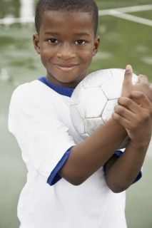 African American boy holding soccer ball
