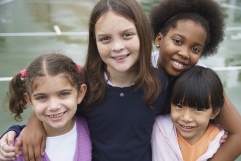 Multi-ethnic children hugging