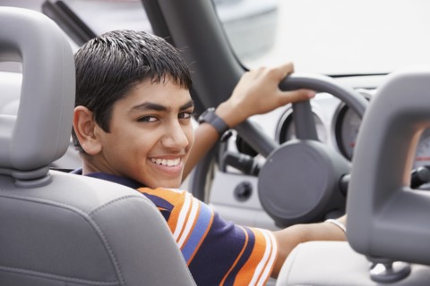 Middle Eastern teenaged boy in car