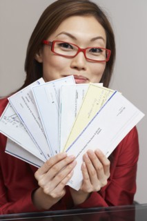 Asian businesswoman holding checks