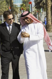 Multi-ethnic businessmen looking at cell phone