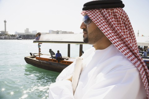 Arab man standing at waterfront
