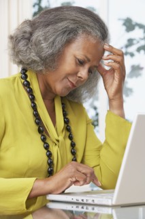 African woman using laptop at home