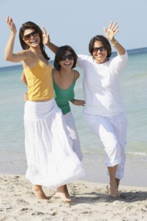 Mother and sisters playing on beach