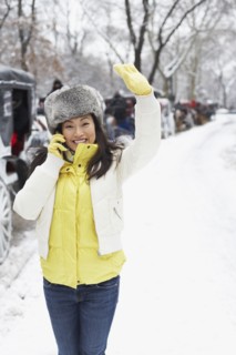 Korean woman talking on cell phone on snowy day