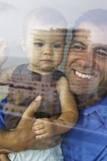 Hispanic father holding daughter
