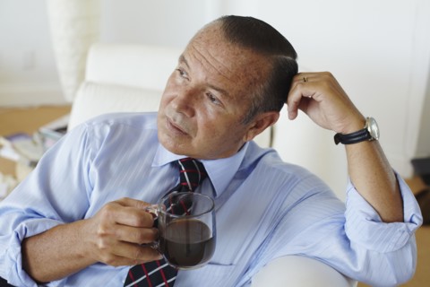 Hispanic businessman drinking coffee