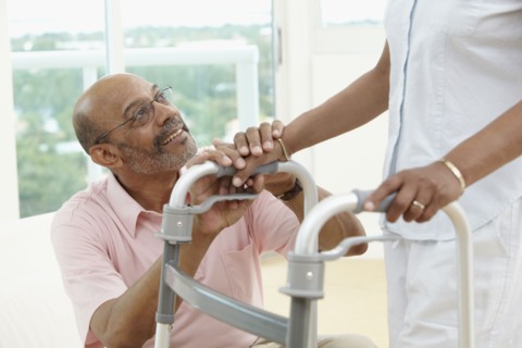 African man encouraging wife using walker