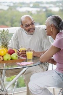 African couple drinking orange juice