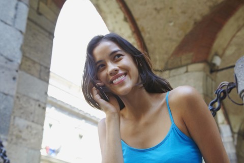 Thai woman talking on cell phone