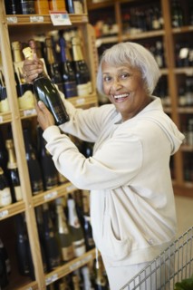 Senior African American woman buying champagne