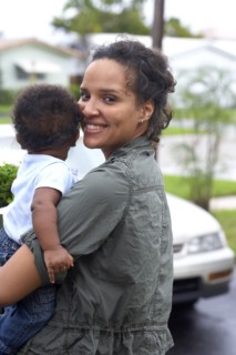 African American mother carrying baby