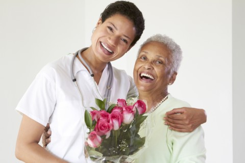 African American woman hugging nurse