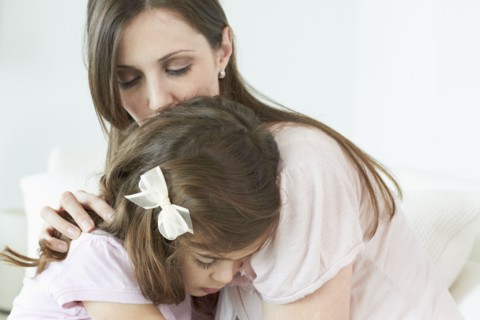 Caucasian woman comforting daughter
