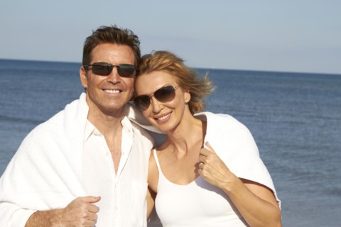 Caucasian couple smiling on beach