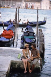 Caucasian sitting together by canal