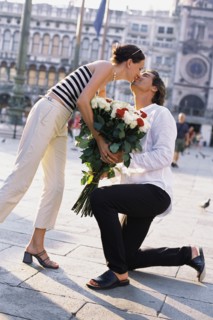 Man giving girlfriend flowers in St. Mark's Square