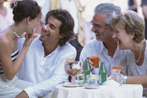 Couples eating together at sidewalk cafe