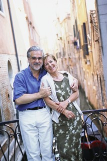 Senior couple hugging over urban canal