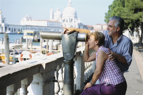 Senior couple looking through telescope