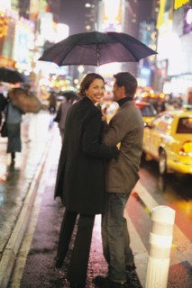 Couple walking on city street at night