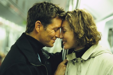 Couple touching foreheads on subway