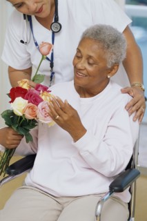 Senior patient getting flowers in hospital