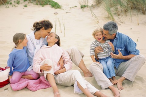 Caucasian family having picnic on beach