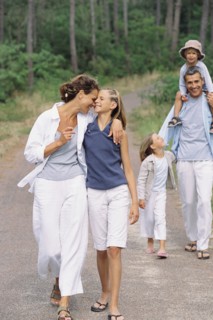 Caucasian family walking in park