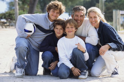Family smiling together in park