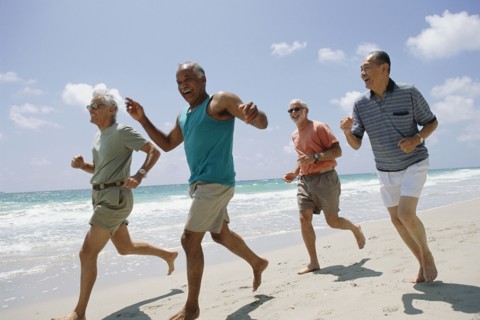 Senior couples jogging on beach