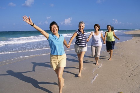 Senior women running on beach