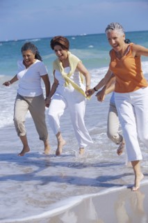 Senior women running on beach