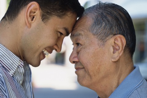 Senior man and son smiling outdoors