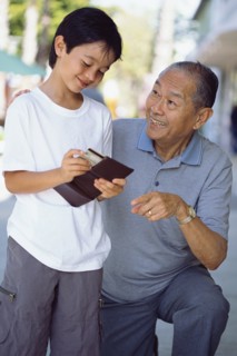 Senior man giving grandson money