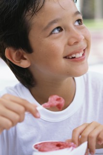 Boy eating ice cream outdoors