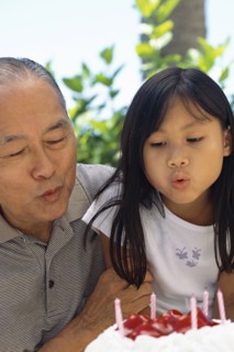 Senior man and granddaughter celebrating birthday