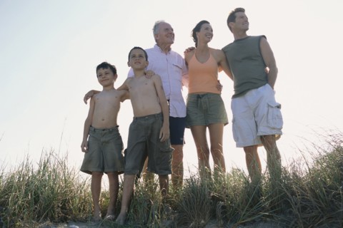 Family overlooking beach from hilltop