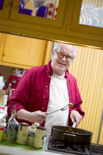 Senior man cooking in kitchen